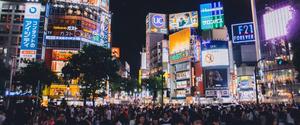 A group of people standing at street level with digital billboards attached to tall buildings in the background. Could these screens become destinations for programmatic digital out-of-home in the future?