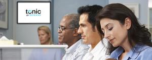 Three people sitting in a waiting room. A Tonic Health Media image is in the background.