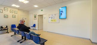 <p>A waiting room that includes a display running content from IDS Media</p>