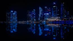 A city in the dark of night, lit up lights in and around its buildings.